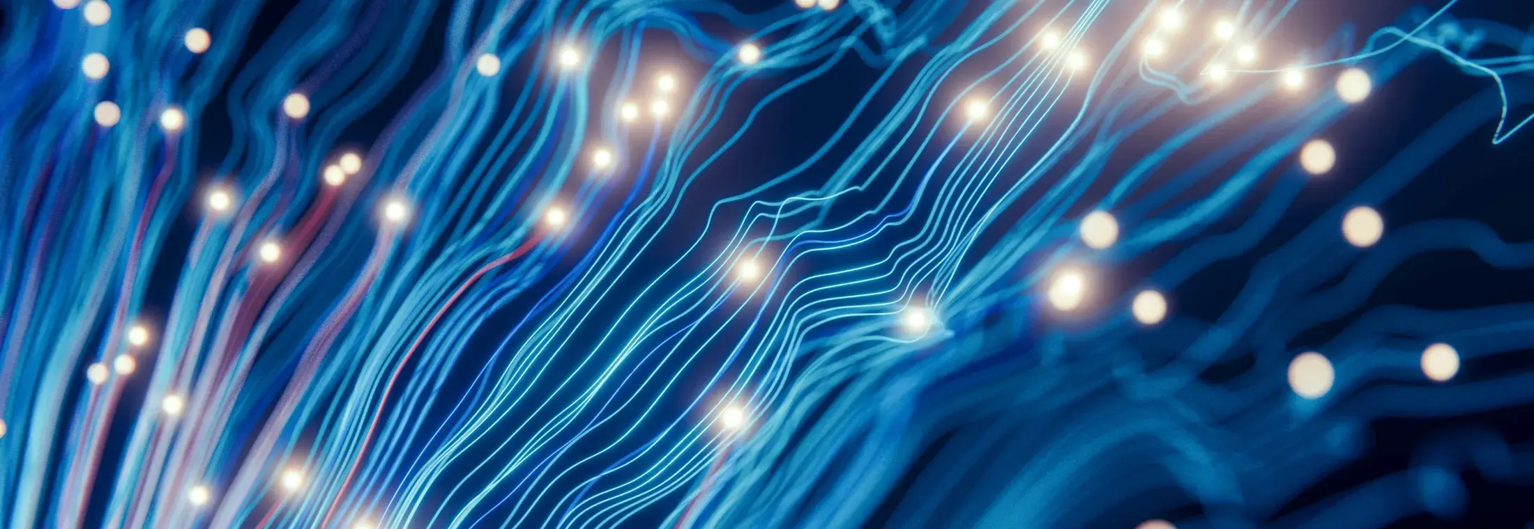 Lignes lumineuses abstraites évoquant les flux de données et les systèmes connectés.